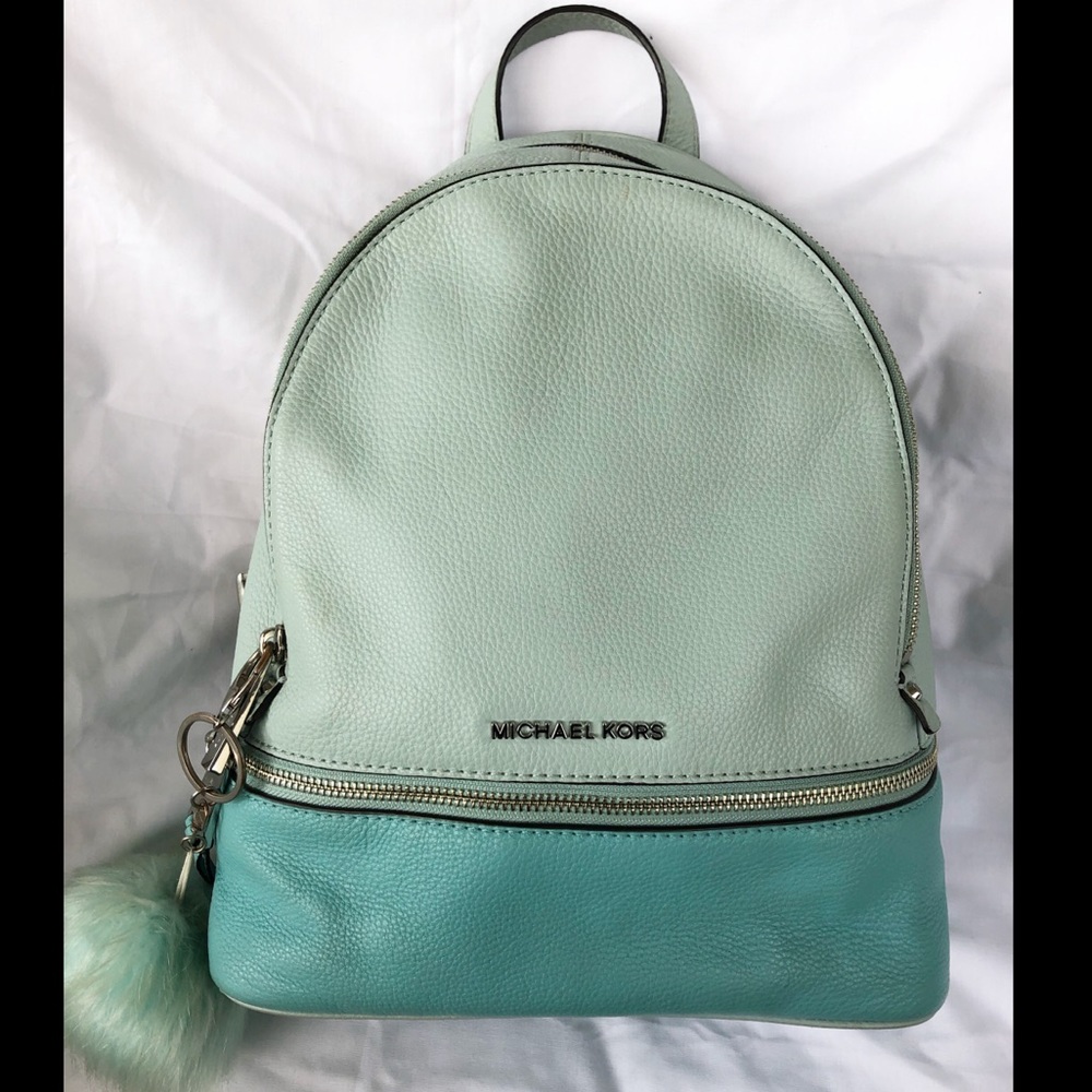 Two toned Mint Michael Kors backpack with a plush key chain